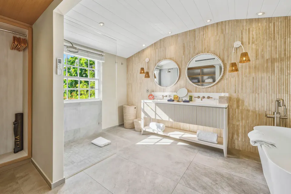 Signature Suite bathroom with twin vanity and soaking tub at Le Toiny Hôtel & Beach Club.