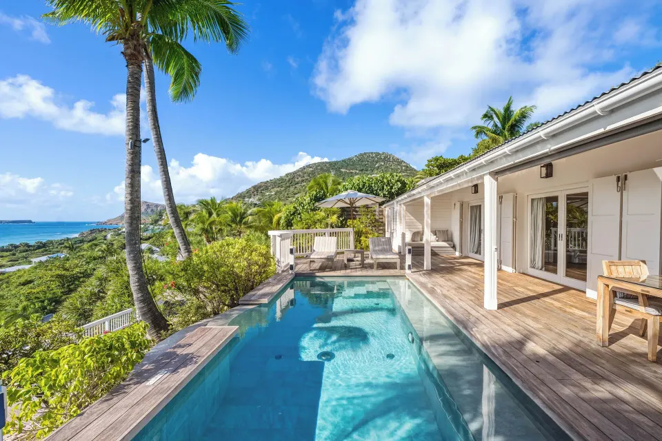 Signature Suite private pool terrace with ocean and hillside views at Le Toiny Hôtel & Beach Club.