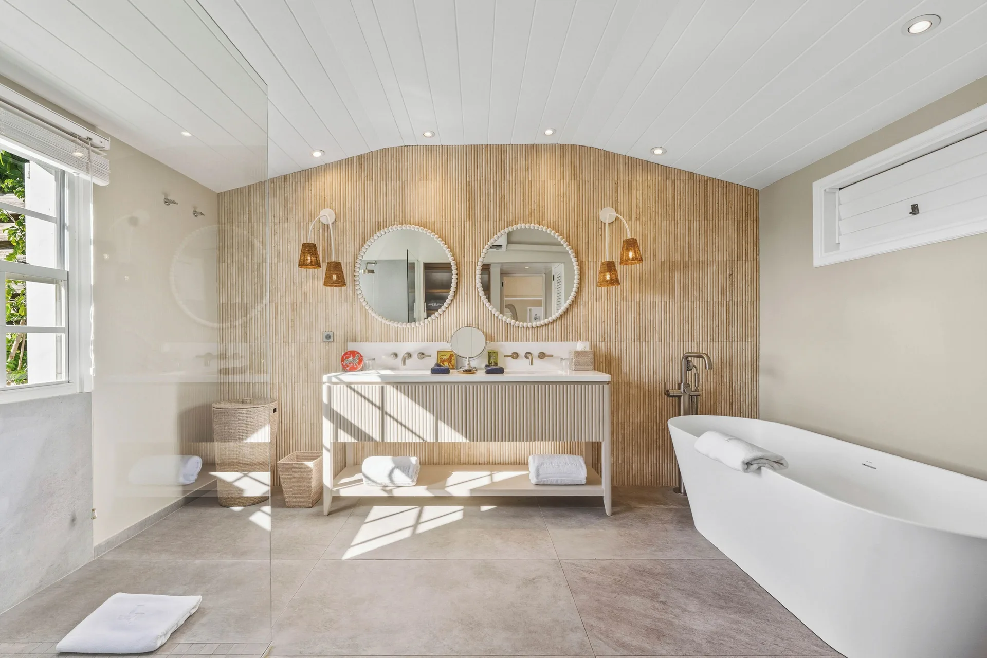 Signature Suite bathroom with double vanity and tub at Le Toiny Hôtel & Beach Club.