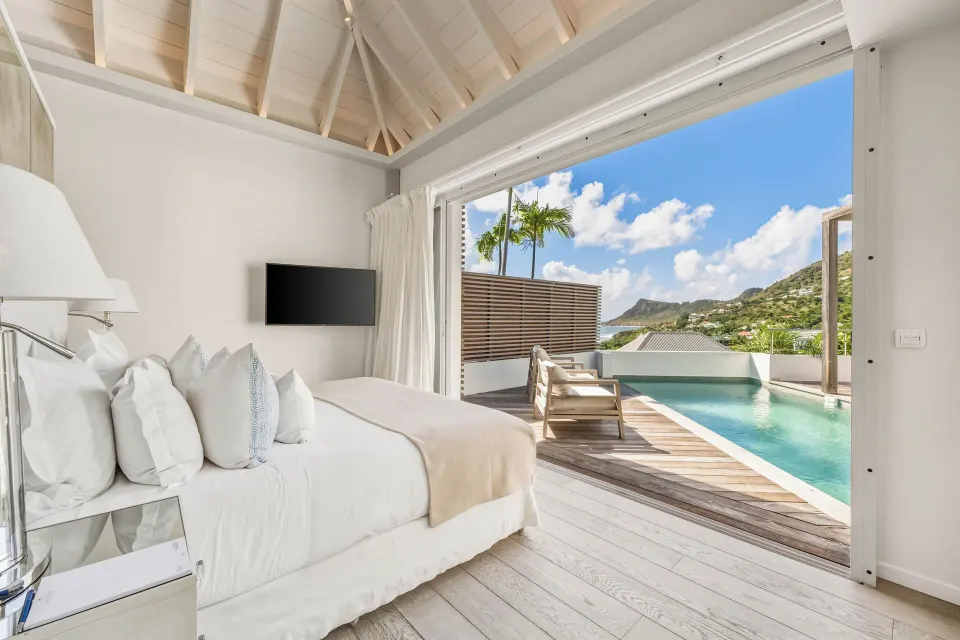 Spirit Suite bedroom opening to a private pool and ocean view at Le Toiny Hôtel & Beach Club.
