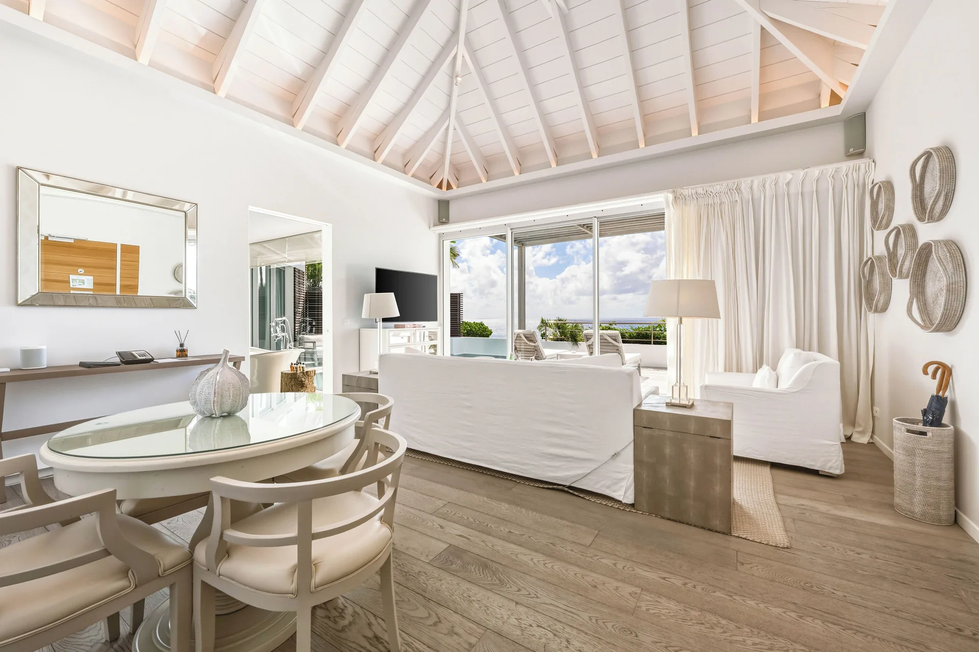 Spirit Suite living area with dining table and ocean-facing terrace at Le Toiny Hôtel & Beach Club.