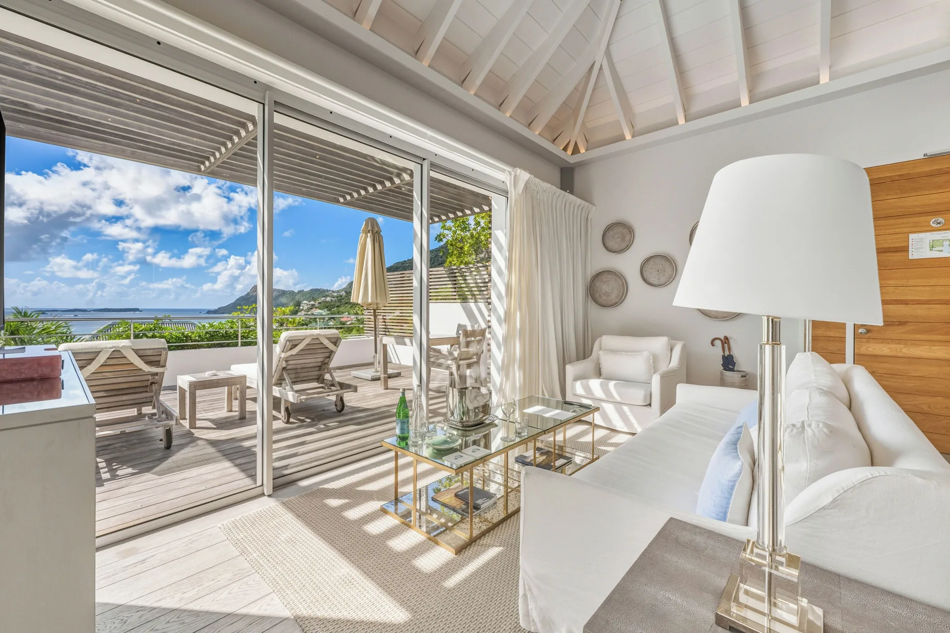 Spirit Suite living room with terrace loungers and ocean view at Le Toiny Hôtel & Beach Club.