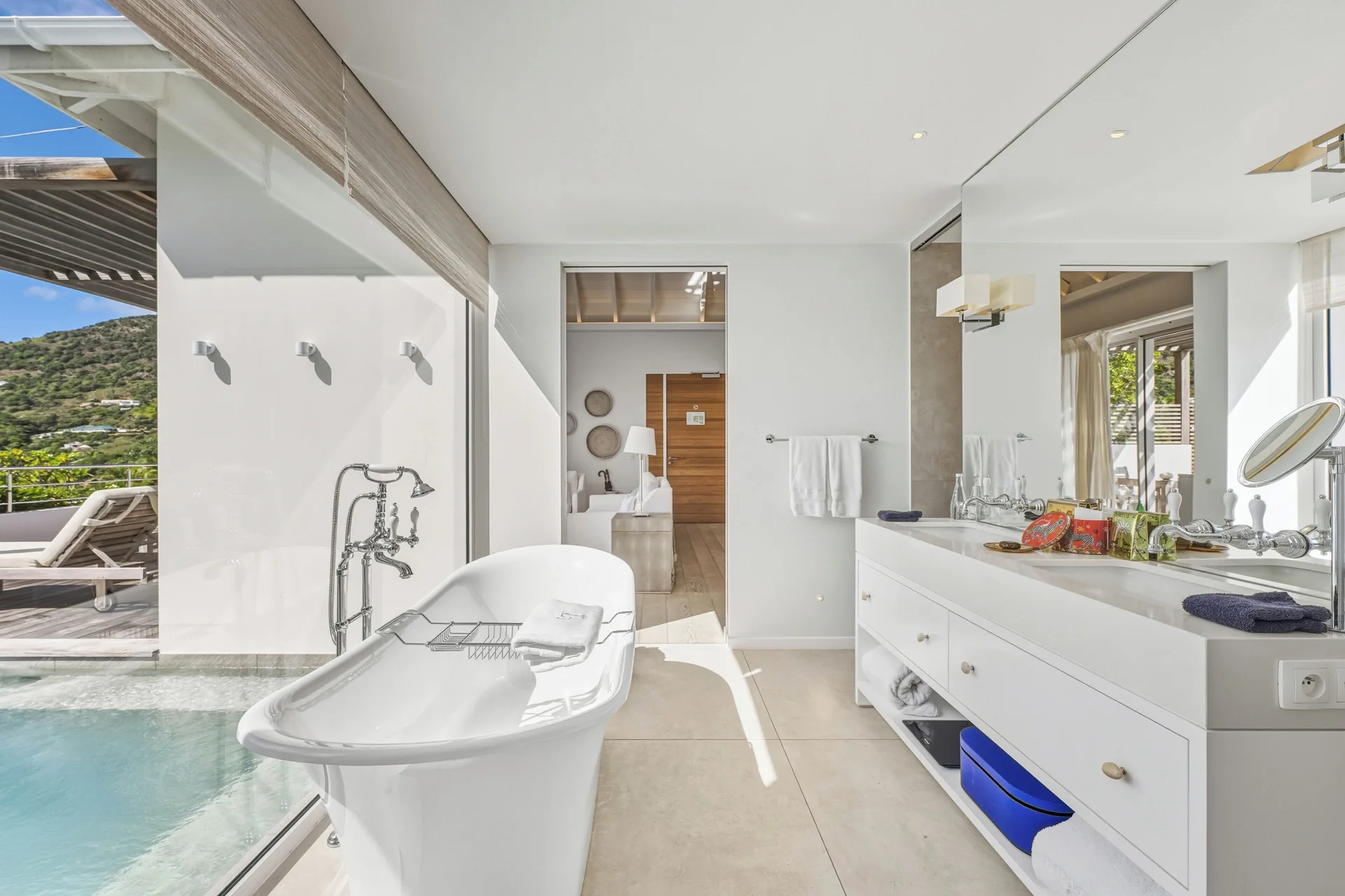 Spirit Suite bathroom vanity and tub overlooking the pool at Le Toiny Hôtel & Beach Club.