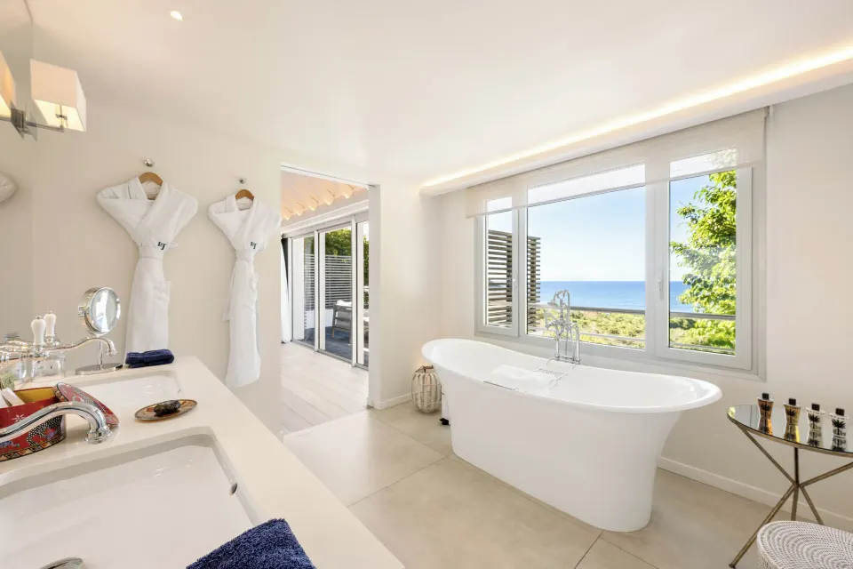 Ocean-view villa bathroom at Le Toiny Hôtel & Beach Club with a freestanding tub and double vanity.