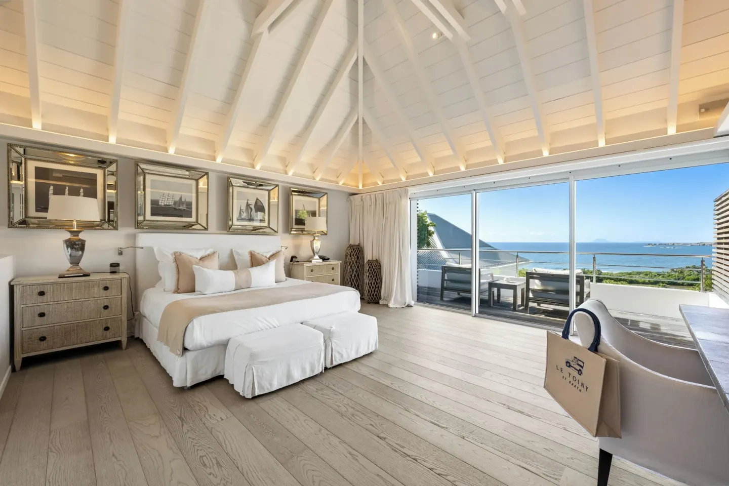 Bedroom with king bed and ocean-facing balcony at Le Toiny Hôtel & Beach Club.