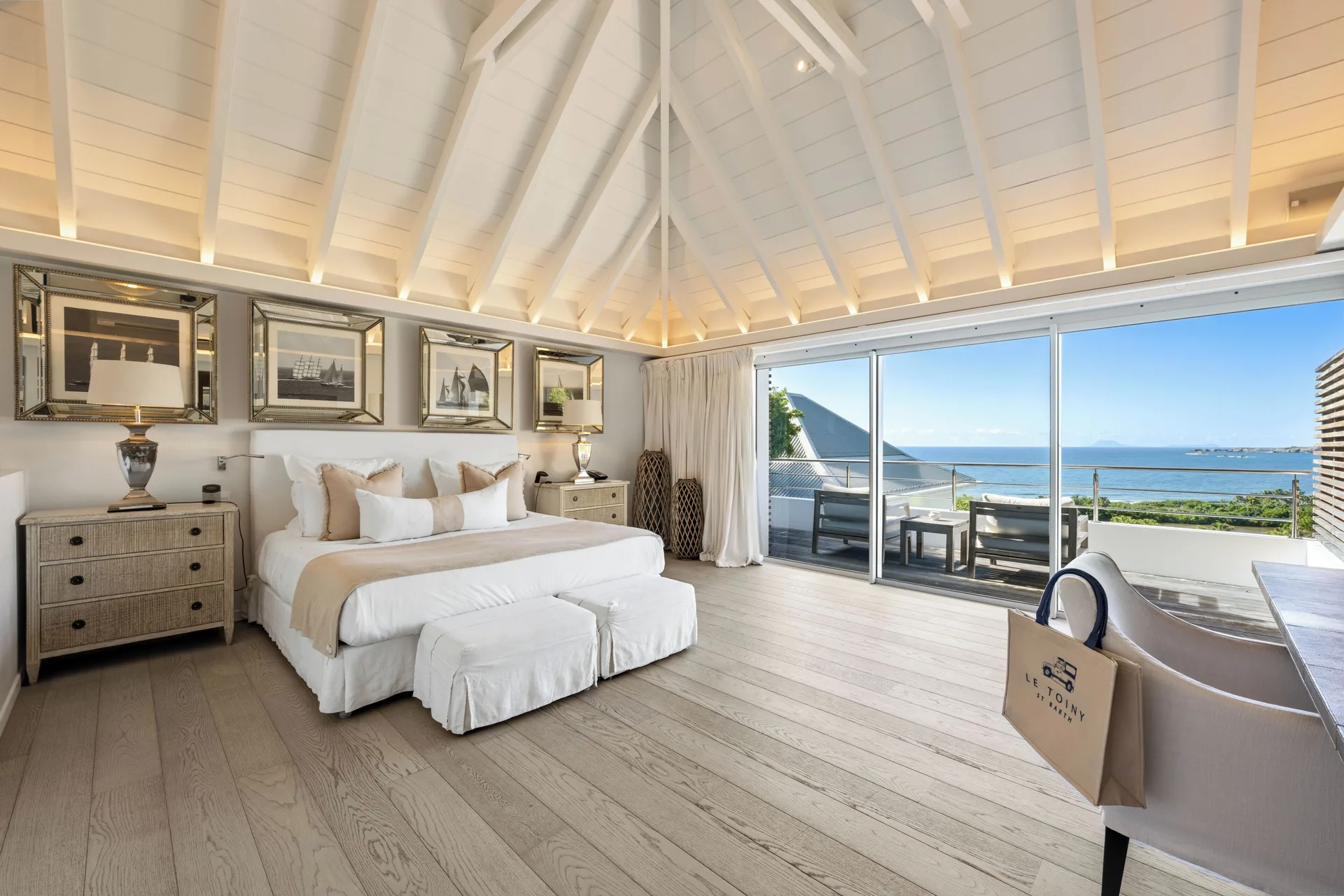 Bedroom with king bed and ocean-facing balcony at Le Toiny Hôtel & Beach Club.