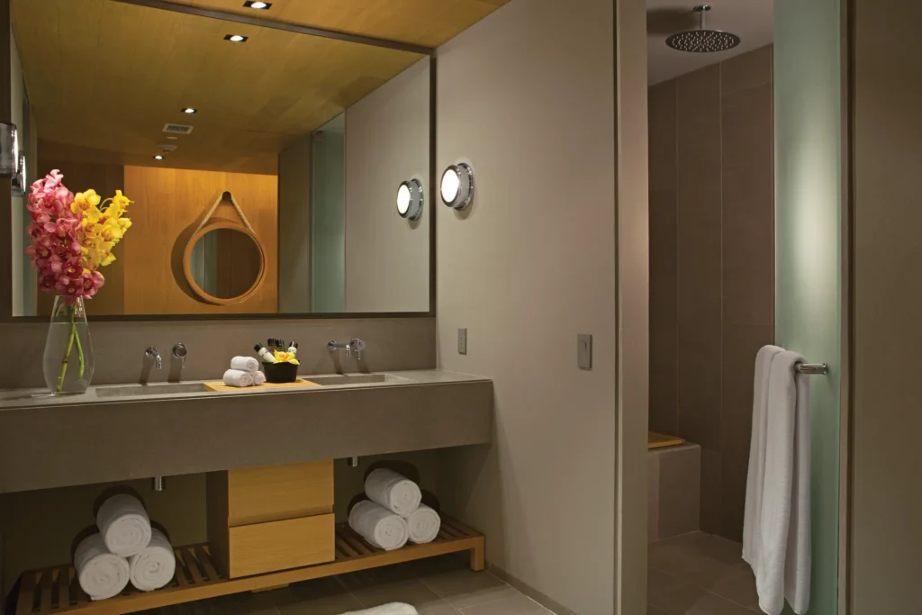 Allure Suite bathroom at Breathless Cabo San Lucas with double vanity, modern décor, and rain shower