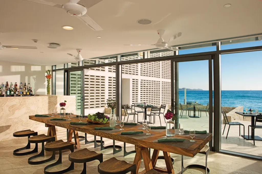Outdoor beachside dining at Barefoot Grill with ocean views at Breathless Cabo San Lucas.