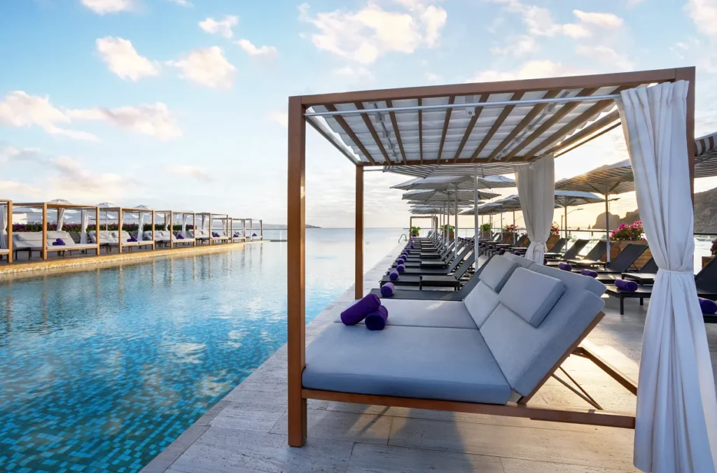 Luxurious poolside cabanas with ocean views at Breathless Cabo San Lucas Beach Club.