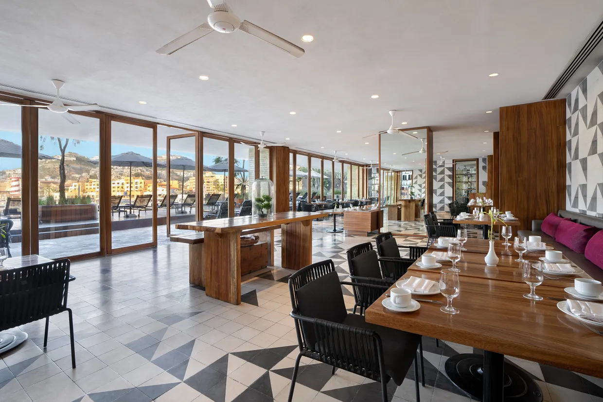Modern indoor dining at Bites restaurant overlooking the Cabo San Lucas marina at Breathless Cabo.