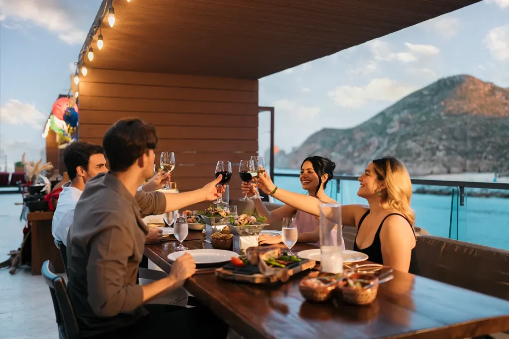 Guests enjoying dinner with marina views at Breathless Cabo San Lucas Restaurant.