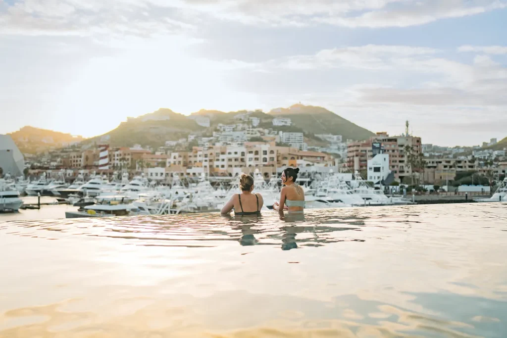 Sunset view from the infinity pool overlooking the marina at Breathless Cabo San Lucas