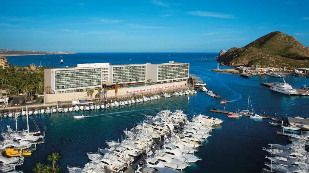 Daytime aerial view of Breathless Cabo San Lucas overlooking the marina and Sea of Cortez.