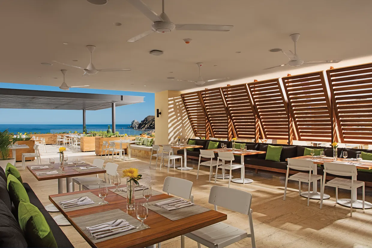 Spoon restaurant breakfast dining area with modern decor and ocean views at Breathless Cabo San Lucas.