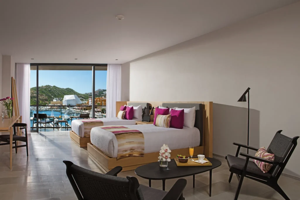 Spacious Xhale Club Suite Marina View with two double beds overlooking the Cabo San Lucas Marina.