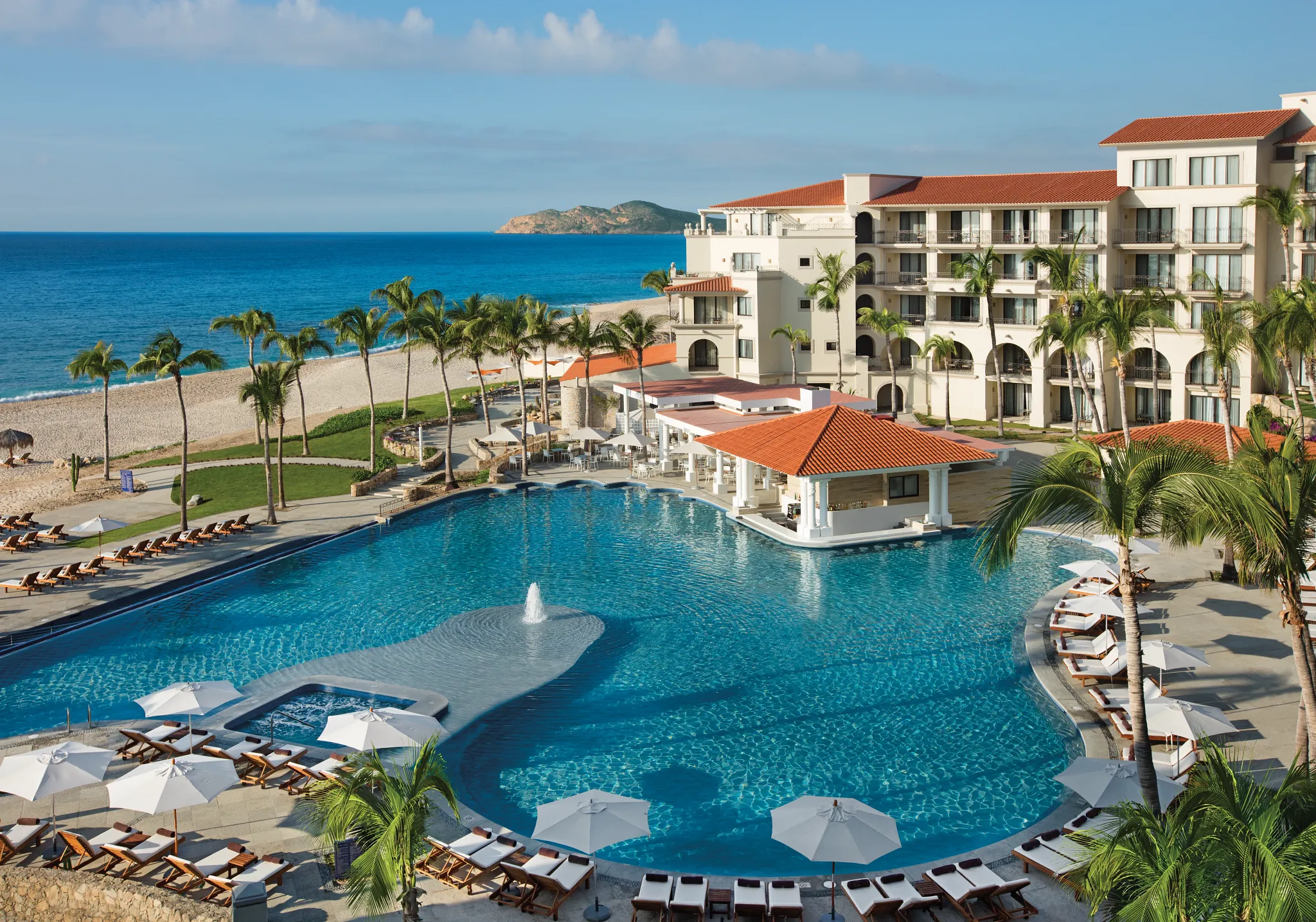 Aerial view of Dreams Los Cabos Suites Golf Resort & Spa with oceanfront pool and beachfront location in the Los Cabos Corridor.