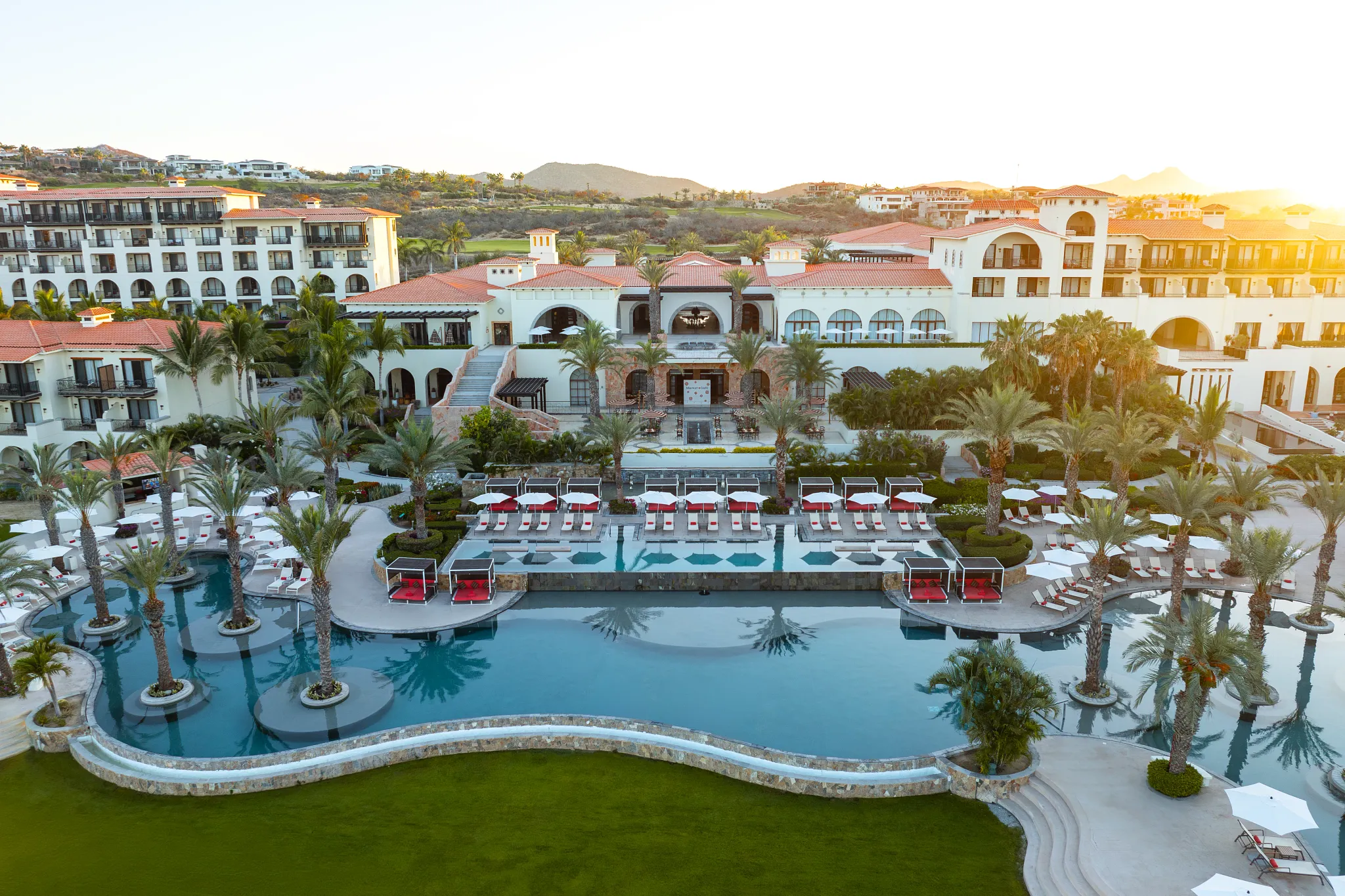Secrets Puerto Los Cabos adults-only resort with oceanfront pools, palm-lined terraces, and luxury suites.