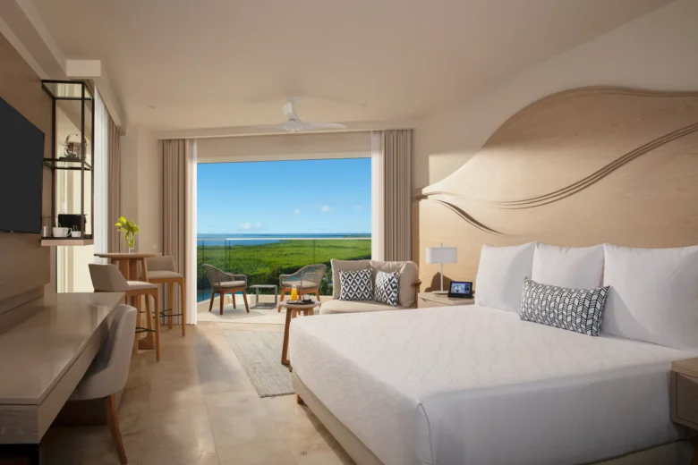 Allure Junior Suite Lagoon View with king bed and private balcony at Breathless Cancun Soul Resort overlooking the lagoon.