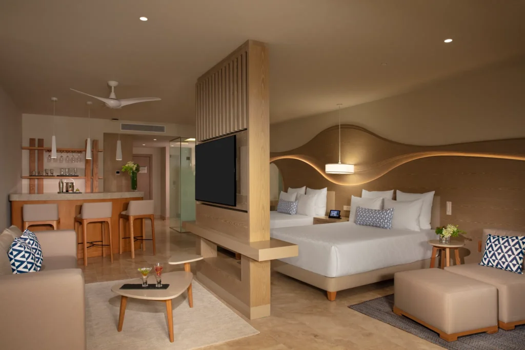 Spacious bedroom with double beds in the Allure Junior Suite Live Big Lagoon View at Breathless Cancun Soul Resort.