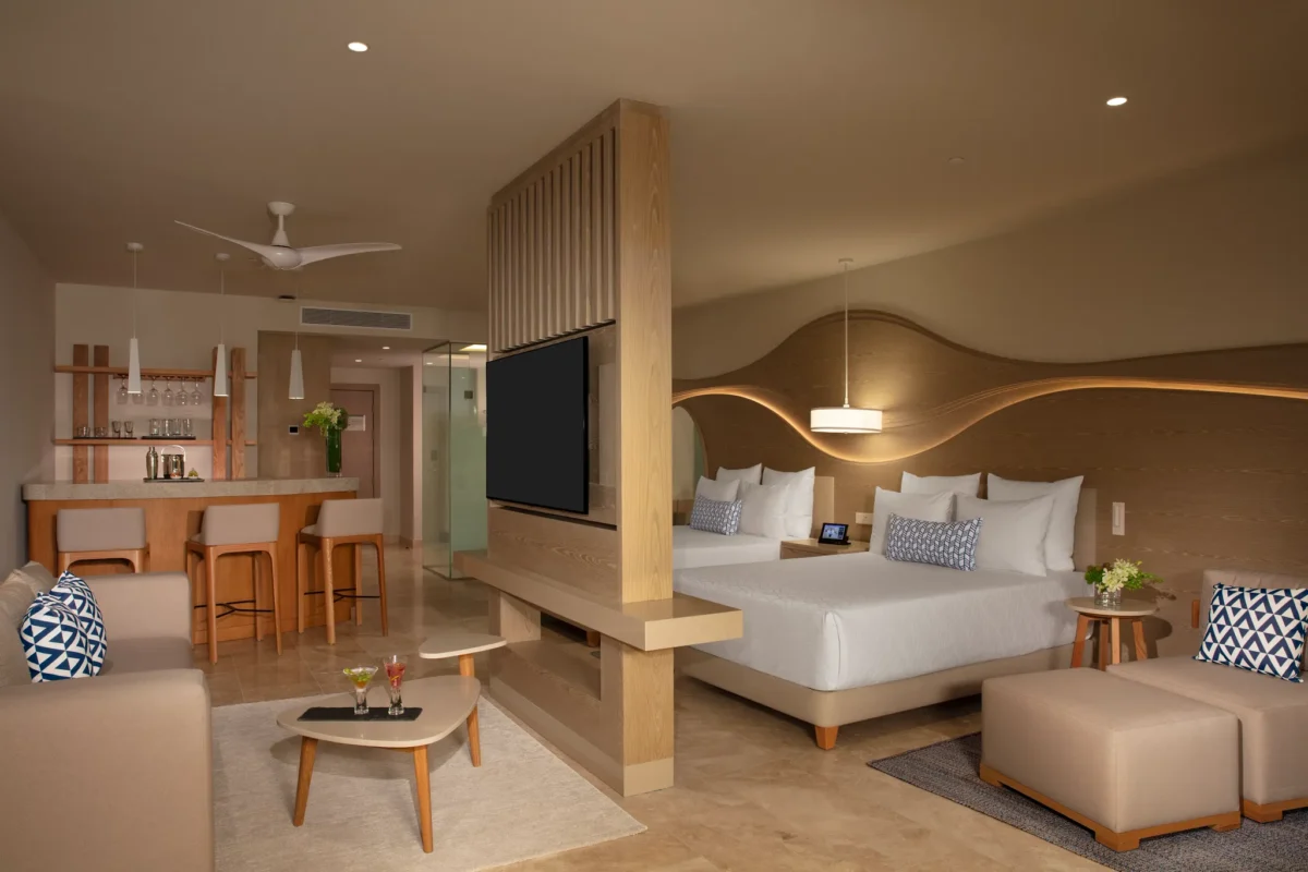 Spacious bedroom with double beds in the Allure Junior Suite Live Big Lagoon View at Breathless Cancun Soul Resort.