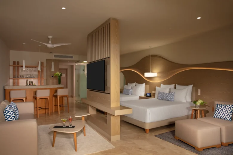 Spacious bedroom with double beds in the Allure Junior Suite Live Big Lagoon View at Breathless Cancun Soul Resort.