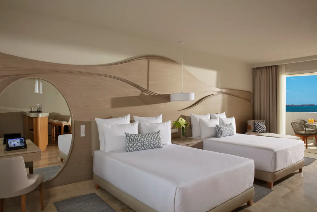 Allure Junior Suite Live Big Lagoon View with double beds at Breathless Cancun Soul Resort overlooking the lagoon.