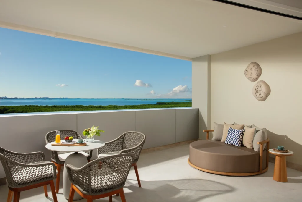 Private terrace with seating and lagoon views in the Allure Junior Suite Live Big Lagoon View at Breathless Cancun Soul Resort.