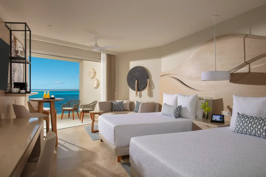 Allure Junior Suite Ocean View with double beds at Breathless Cancun Soul Resort overlooking the Caribbean Sea.