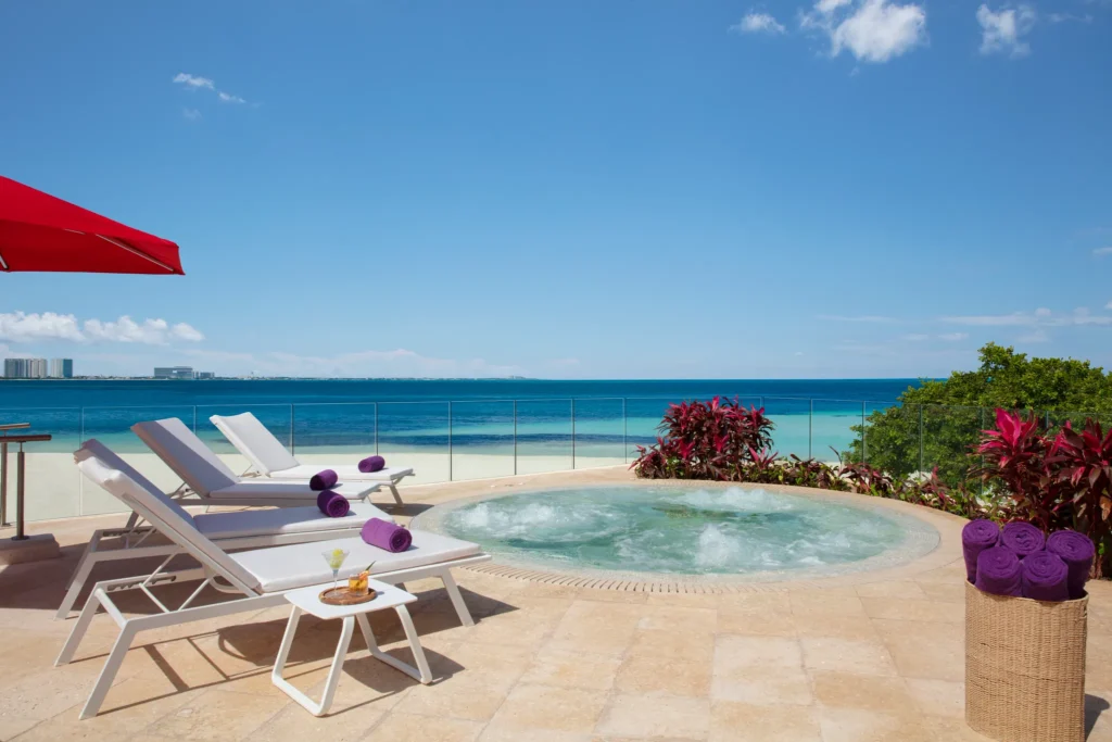 Oceanfront whirlpool with lounge chairs at Breathless Cancun Soul Resort overlooking the Caribbean Sea.