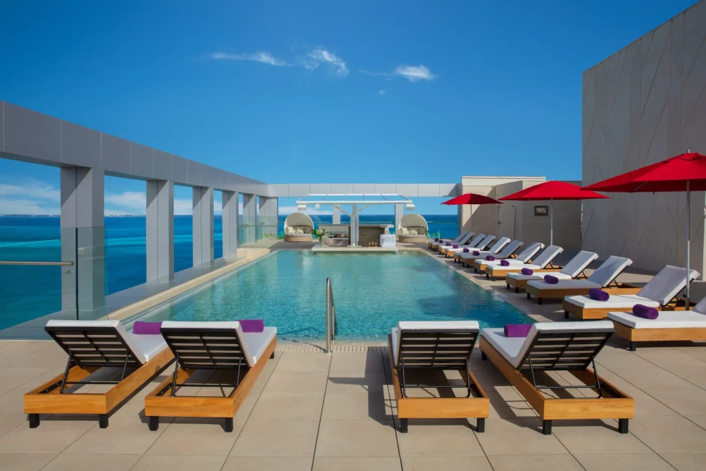 Daytime view of the Xcelerate Pool at Breathless Cancun Soul Resort overlooking the Caribbean Sea.