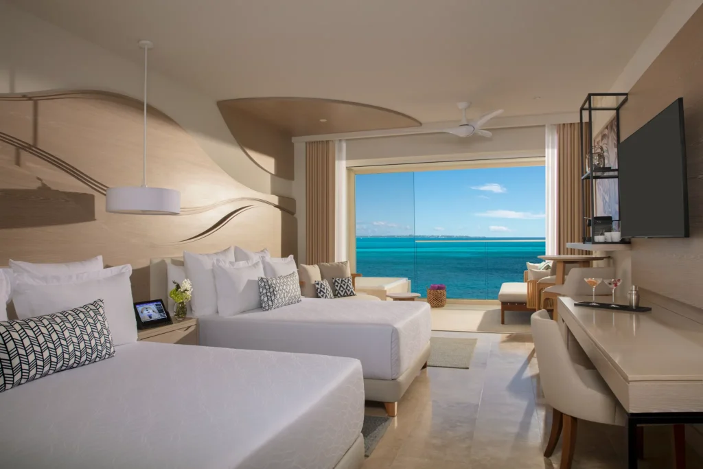 Xhale Club Junior Suite Upper Ocean Front with double beds and Jacuzzi at Breathless Cancun Soul Resort with ocean views.