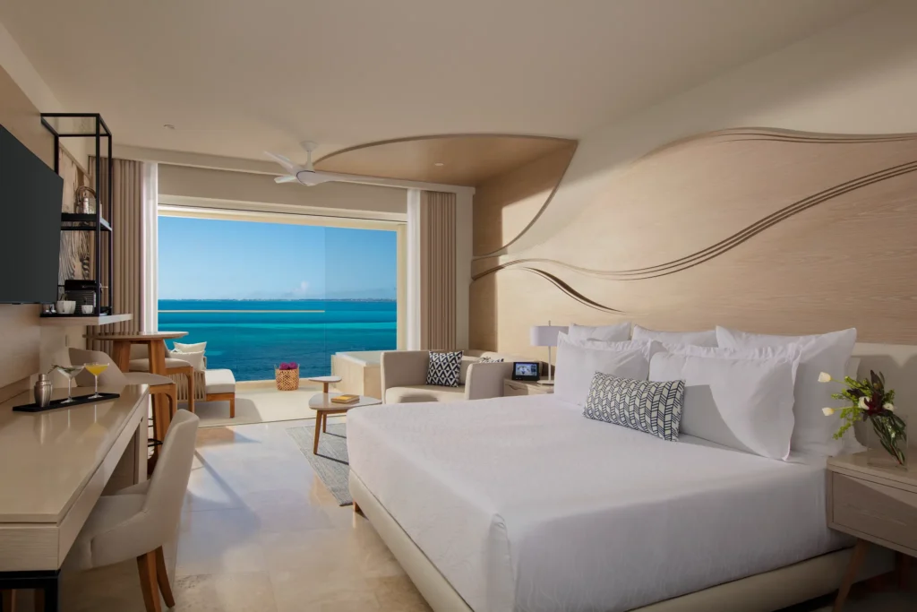 Xhale Club Junior Suite Upper Ocean Front with king bed and Jacuzzi at Breathless Cancun Soul Resort overlooking the Caribbean Sea.