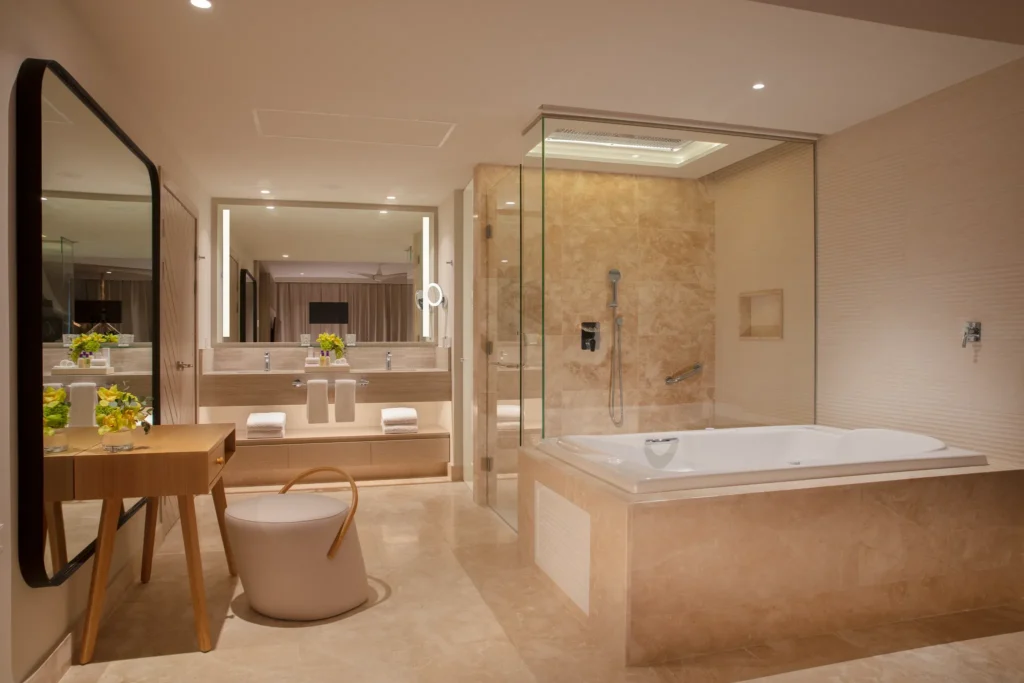 Luxury bathroom in the Xhale Club Master Suite Ocean Front at Breathless Cancun Soul Resort with soaking tub and glass shower.