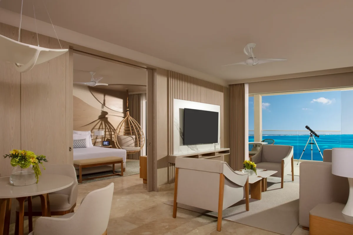 Spacious living area in the Xhale Club Master Suite Ocean Front at Breathless Cancun Soul Resort with modern seating and ocean views.