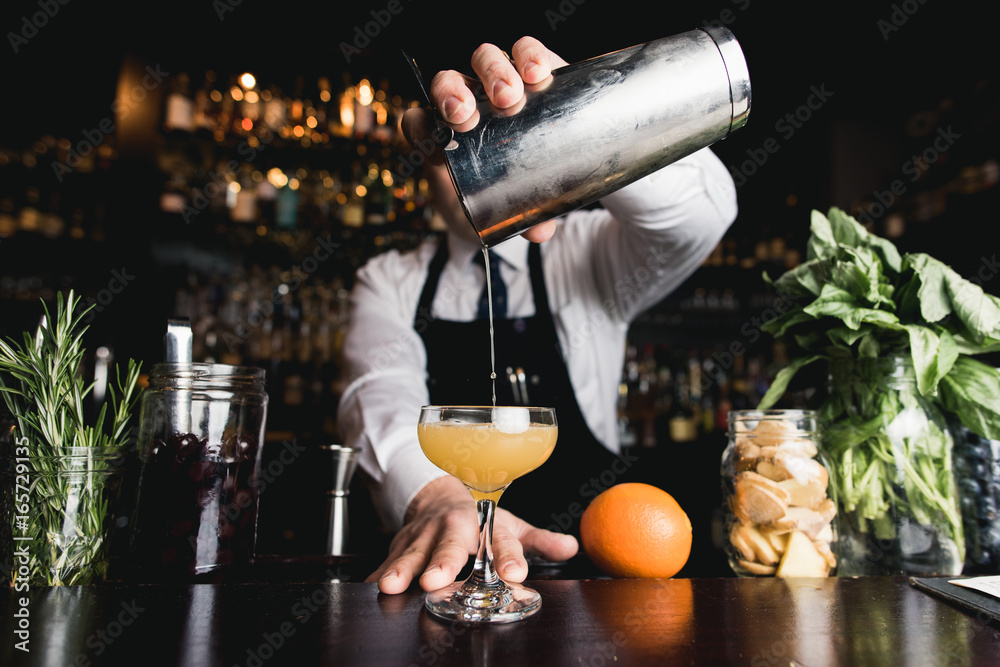 Bartender pouring cocktail
