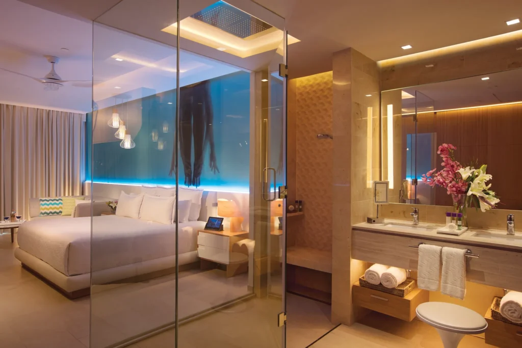 Allure Junior Suite Tropical View bathroom vanity at Breathless Montego Bay featuring dual sinks, glass shower, and modern ambient lighting.