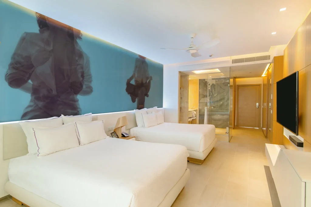 Allure Junior Suite Tropical View room at Breathless Montego Bay with two beds and balcony showcasing tropical landscape and resort pools.