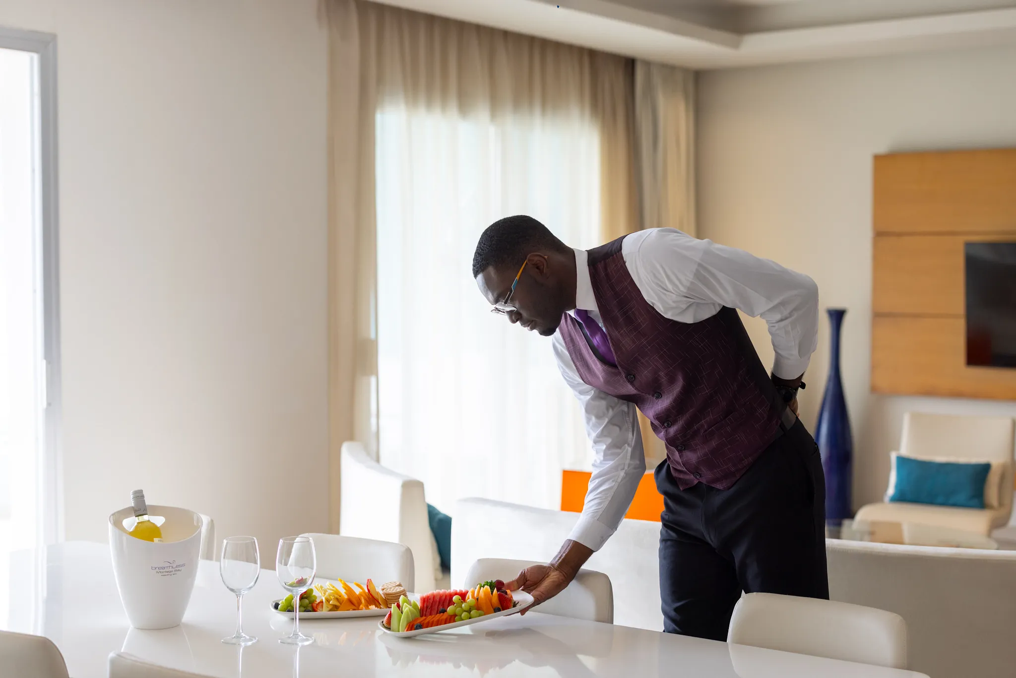 Butler preparing an in-suite fruit platter at Breathless Montego Bay.