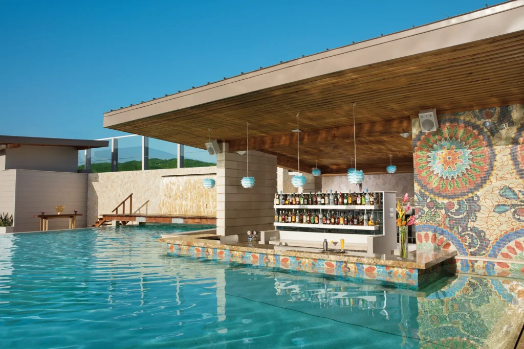 Freestyle Swim-Up Bar at Breathless Montego Bay with a mosaic backdrop and in-pool seating.