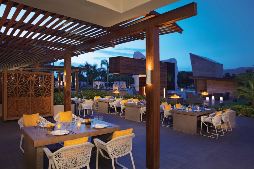 Outdoor terrace dining at Sofrito Restaurant at Breathless Montego Bay with evening lighting and modern seating.