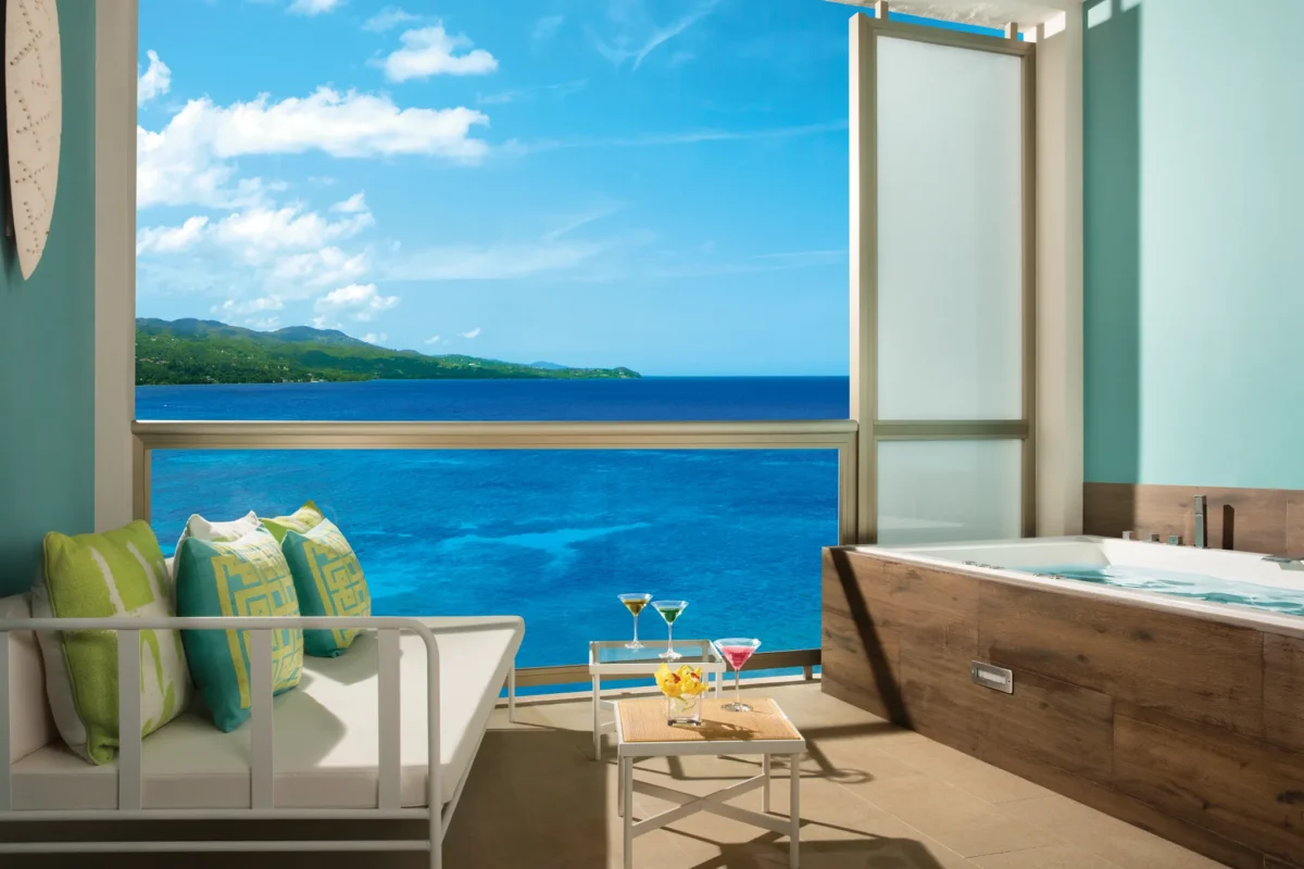 Xhale Club Junior Suite Ocean View terrace at Breathless Montego Bay with outdoor seating, private whirlpool tub, and sweeping Caribbean Sea views.