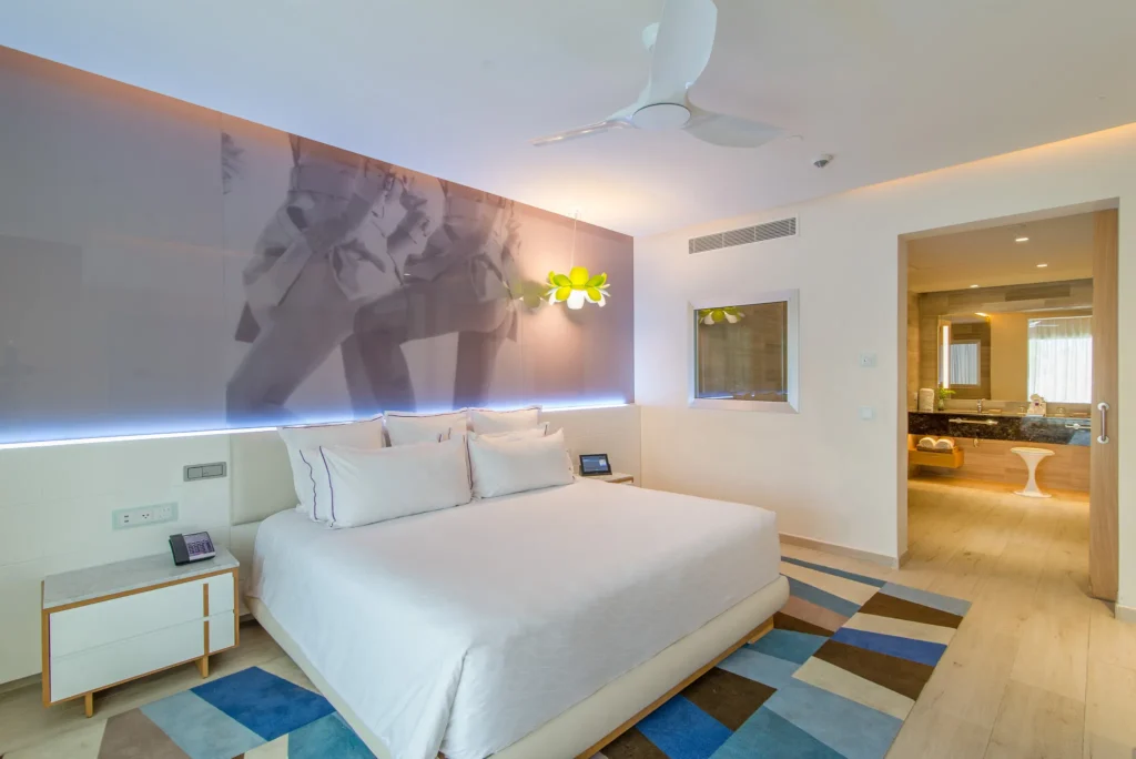Xhale Club Master Suite Swim-Up bedroom at Breathless Montego Bay with king bed, modern décor, and direct access to the swim-out terrace.