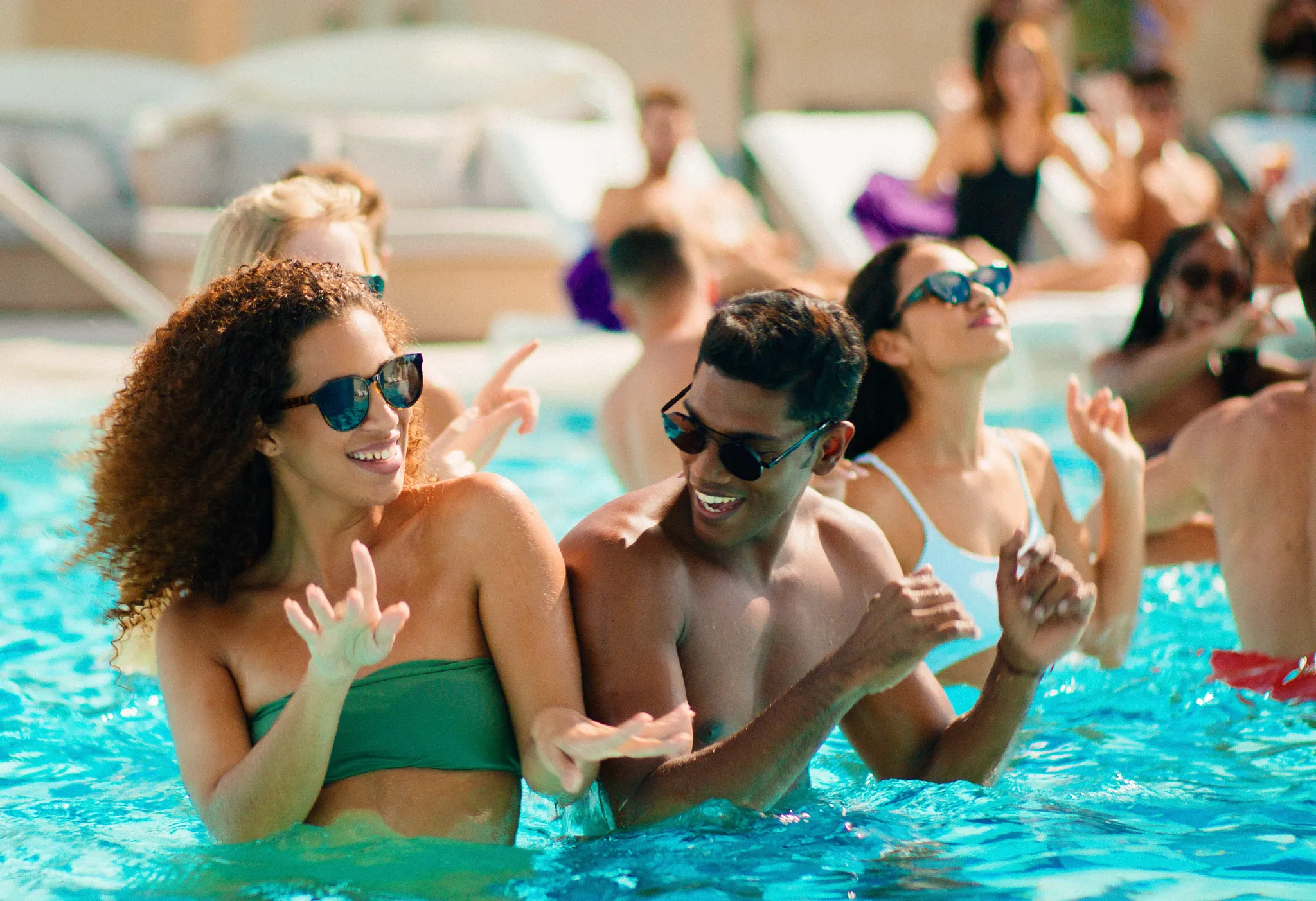 Friends enjoying a high-energy pool party