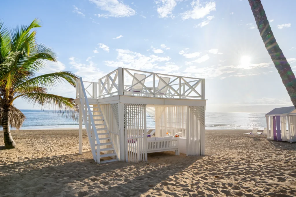 Beachfront cabanas and palm trees forming a tranquil beach oasis at Breathless Punta Cana.