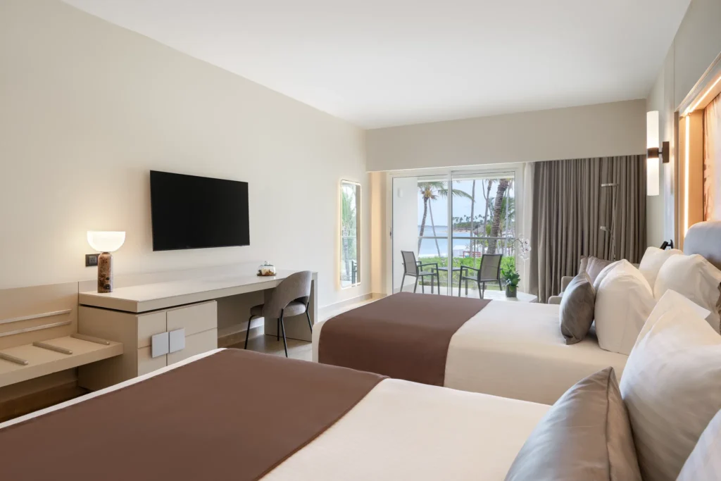 Xhale Club Junior Suite Partial Ocean View with double beds and private terrace at Breathless Punta Cana Resort.