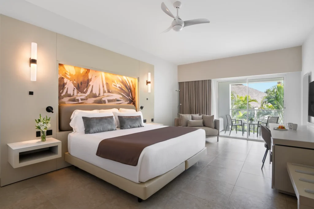 Xhale Club Junior Suite Tropical View with king bed and private balcony at Breathless Punta Cana Resort.