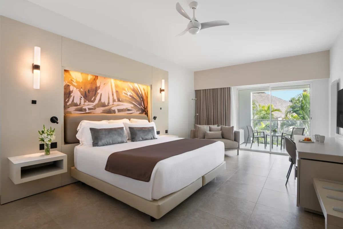 Xhale Club Junior Suite Tropical View with king bed and private balcony at Breathless Punta Cana Resort.