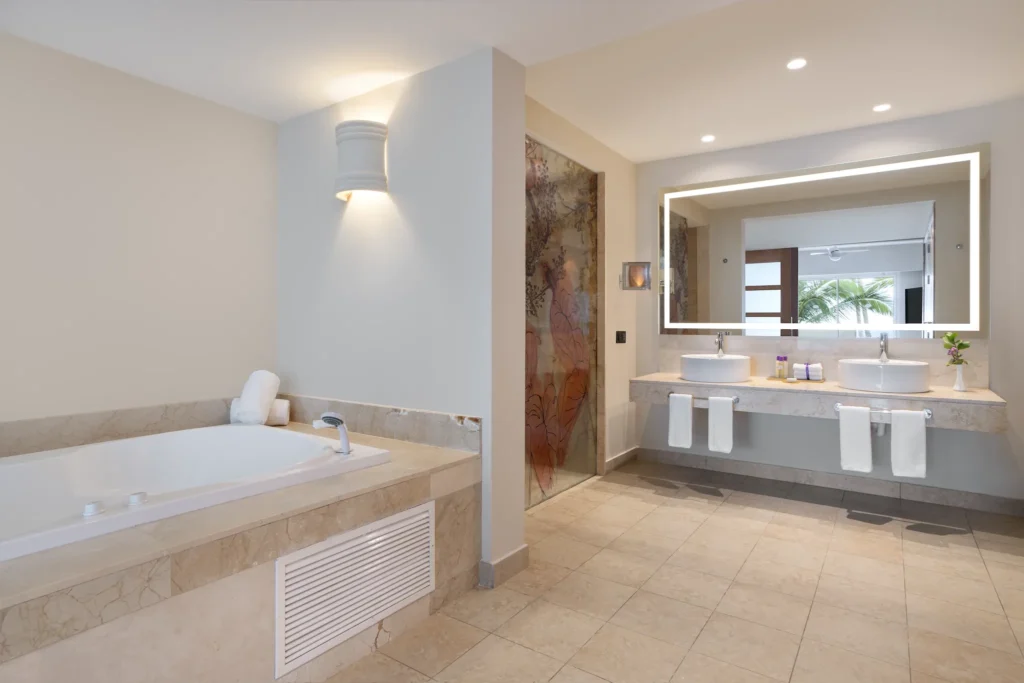 Xhale Club Master Suite Ocean Front bathroom with soaking tub, double vanity, and rain shower at Breathless Punta Cana Resort.