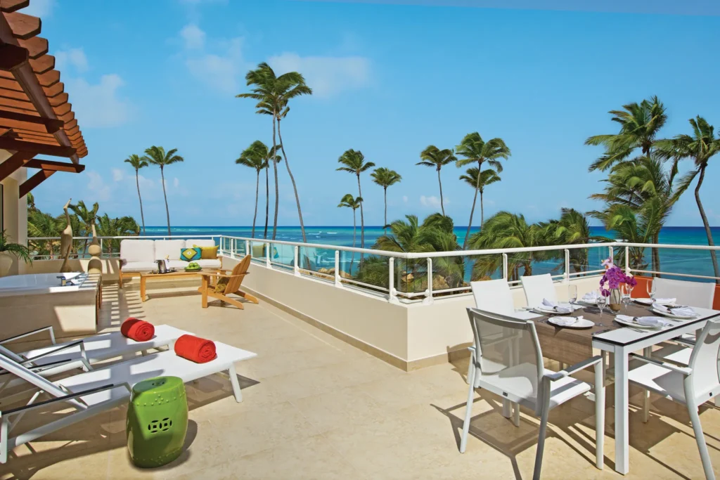 Xhale Club Presidential Suite oceanfront terrace with dining area and hot tub at Breathless Punta Cana Resort.