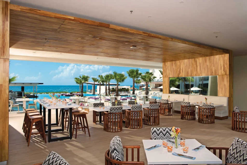 Bites poolside restaurant at Breathless Riviera Cancun Resort & Spa with ocean views and open-air dining